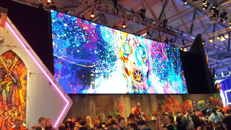 Bunte großflächige Borderlands-3-Grafik über einem dicht besuchten Messestand.